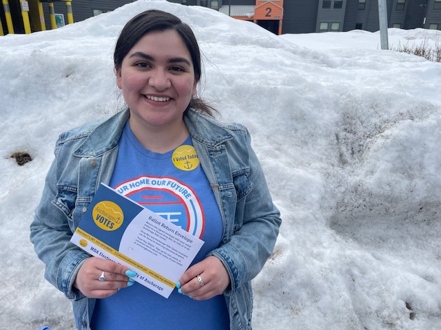 An Alaskan voter holding a ballot